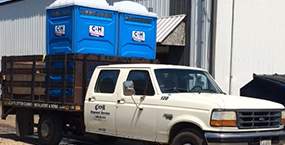 Portable toilets being delivered to client by C & H Disposal Service, Inc.